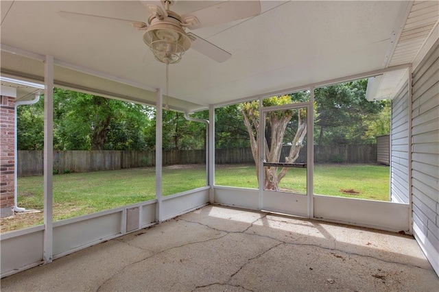 unfurnished sunroom featuring ceiling fan