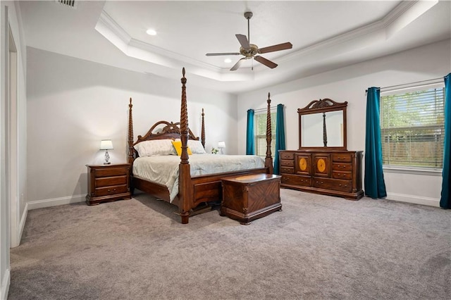 bedroom featuring baseboards, crown molding, carpet, and a raised ceiling