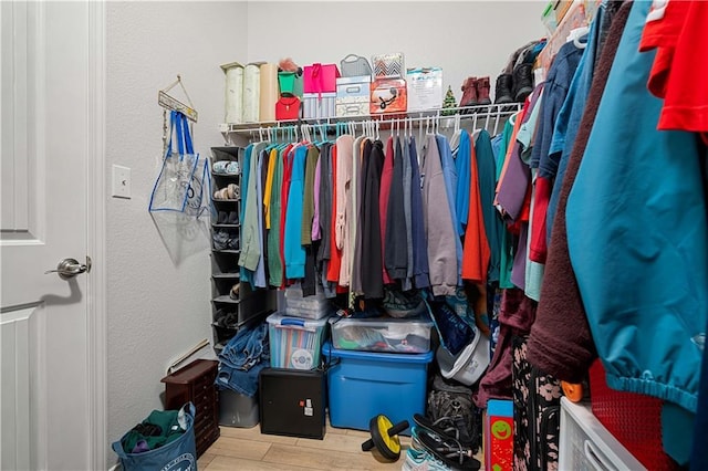 walk in closet featuring wood finished floors