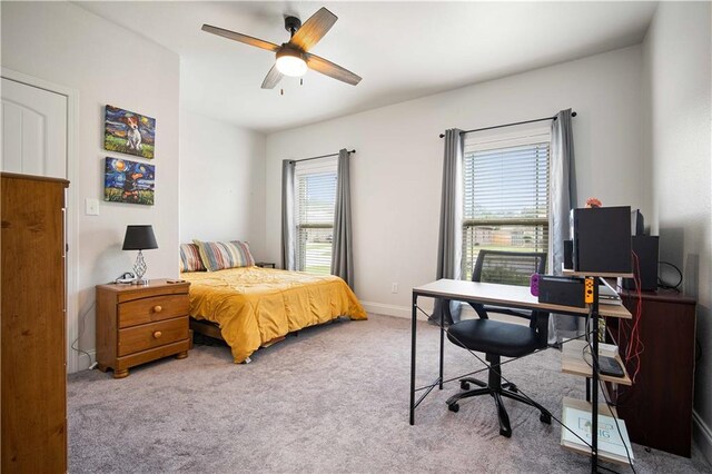 bedroom with multiple windows and light hardwood / wood-style flooring