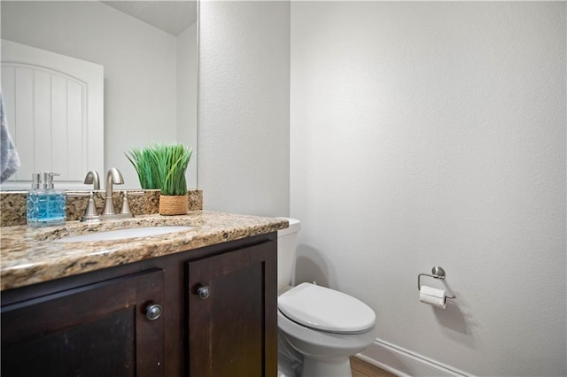bathroom with toilet and vanity