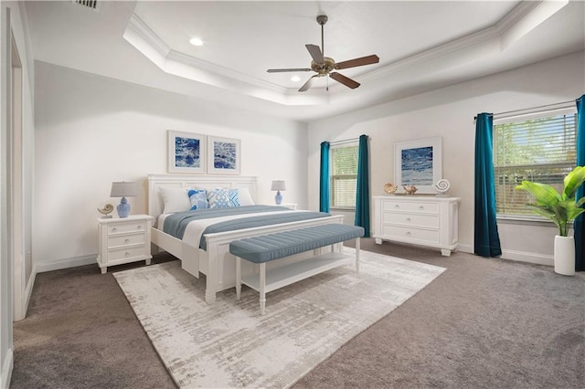 bedroom featuring a tray ceiling, baseboards, carpet floors, and ornamental molding