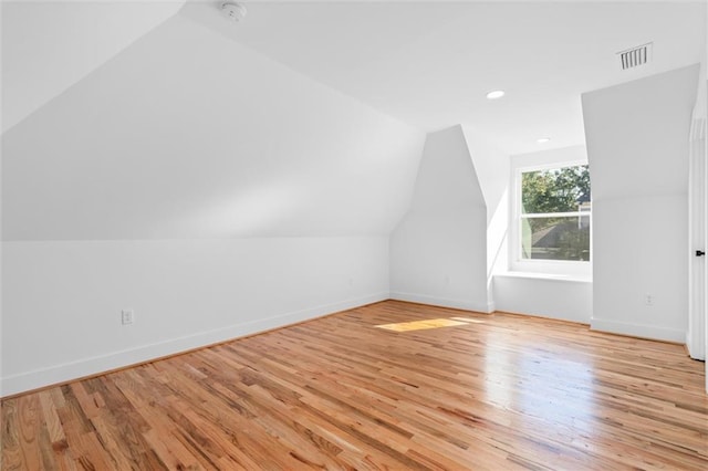 bonus room with light hardwood / wood-style flooring and vaulted ceiling