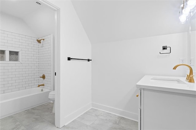 full bathroom featuring toilet, lofted ceiling, vanity, and tiled shower / bath