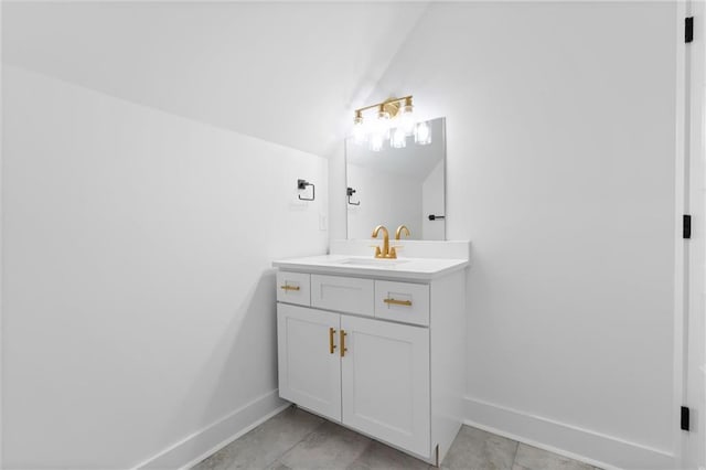 bathroom featuring vanity, vaulted ceiling, and tile patterned floors