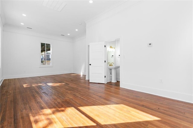 spare room featuring crown molding, sink, and dark hardwood / wood-style floors