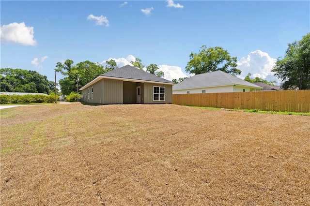 rear view of house featuring a lawn