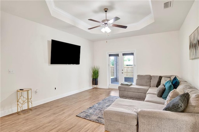 1468 Surrey Loop, Foley, AL 36535 - living room featuring a tray ceiling, wood finished floors, a ceiling fan, crown molding, and baseboards