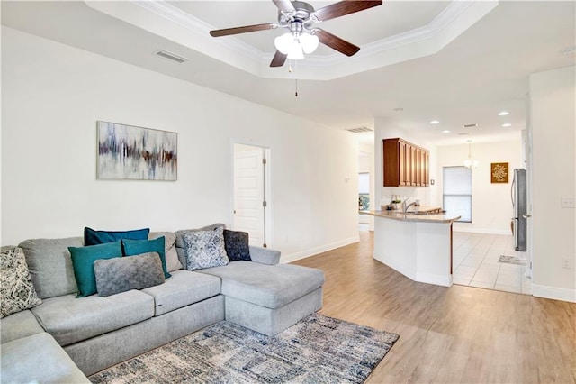 1468 Surrey Loop, Foley, AL 36535 - living room featuring a raised ceiling, light wood finished floors, a ceiling fan, recessed lighting, and baseboards