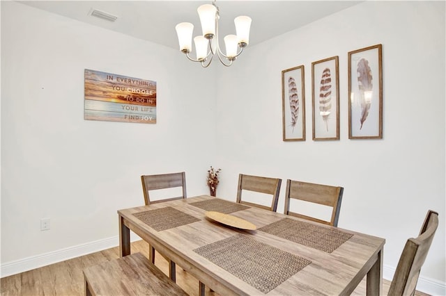 1468 Surrey Loop, Foley, AL 36535 - dining area featuring a chandelier, wood finished floors, and baseboards