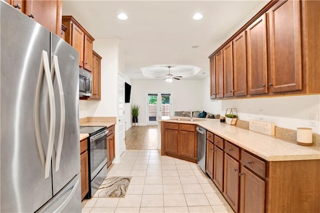 1468 Surrey Loop, Foley, AL 36535 - kitchen with appliances with stainless steel finishes, a peninsula, a ceiling fan, recessed lighting, and light tile patterned flooring