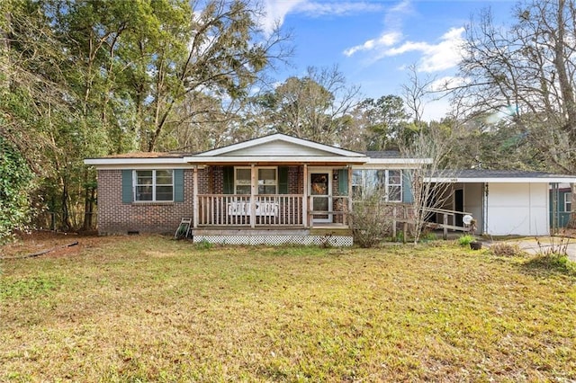 single story home featuring covered porch and a front yard