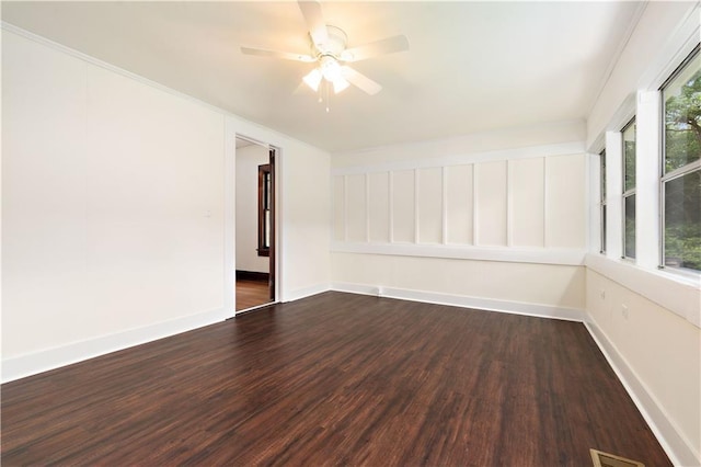 unfurnished room with ceiling fan and dark hardwood / wood-style flooring