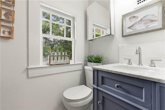 bathroom with vanity and toilet