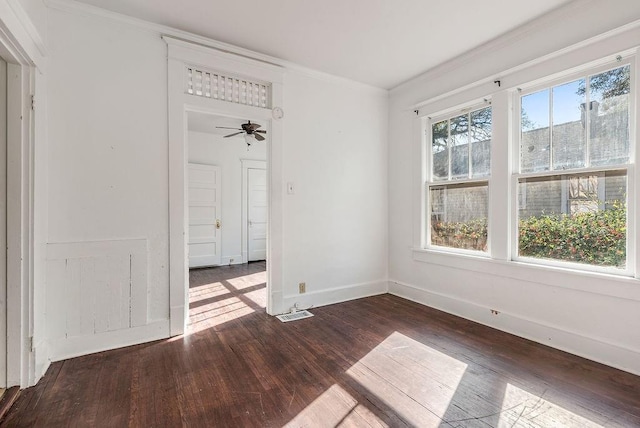 spare room with baseboards, crown molding, a ceiling fan, and wood-type flooring