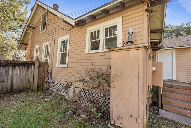 view of property exterior featuring fence