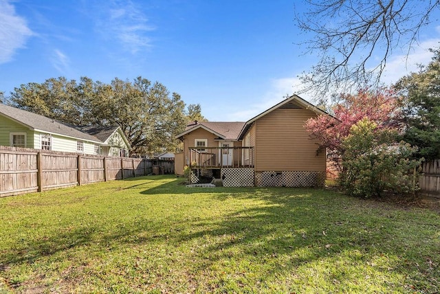 exterior space featuring a wooden deck and a fenced backyard