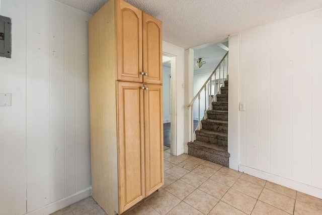 interior space with tile patterned flooring and a textured ceiling