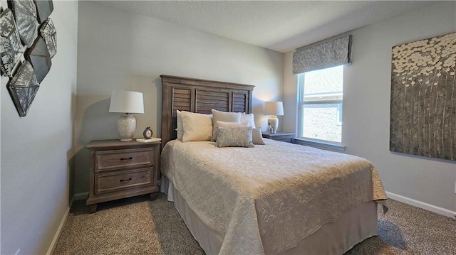 bedroom featuring dark carpet and baseboards