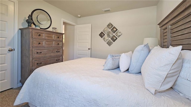 bedroom featuring light colored carpet and visible vents