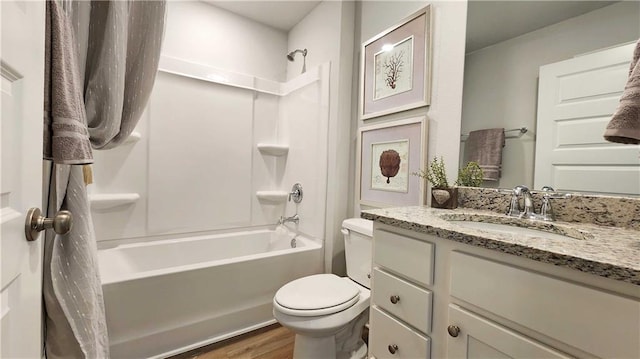 bathroom with toilet, shower / bathtub combination with curtain, wood finished floors, and vanity