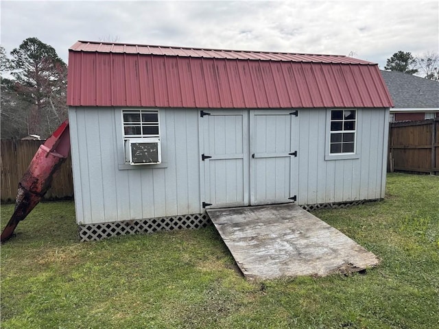 view of shed featuring fence