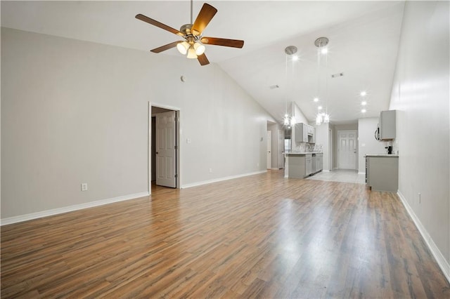 647 Spring Lake Ct, Mobile, AL 36695 - unfurnished living room with ceiling fan, high vaulted ceiling, and light wood-type flooring