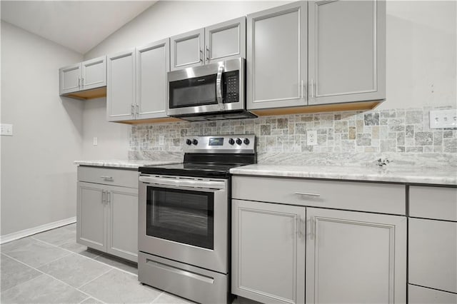 647 Spring Lake Ct, Mobile, AL 36695 - kitchen featuring stainless steel appliances, backsplash, lofted ceiling, and gray cabinets