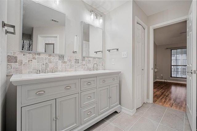 647 Spring Lake Ct, Mobile, AL 36695 - bathroom with double vanity, tile patterned flooring, and backsplash