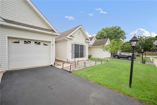 647 Spring Lake Ct, Mobile, AL 36695 - ranch-style house featuring a front lawn, a garage, and driveway