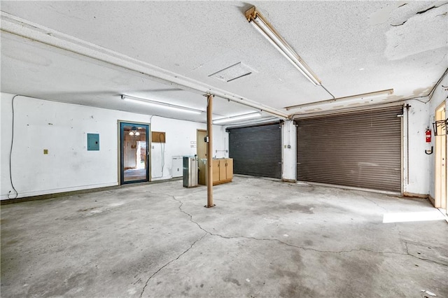 garage with electric panel and baseboards