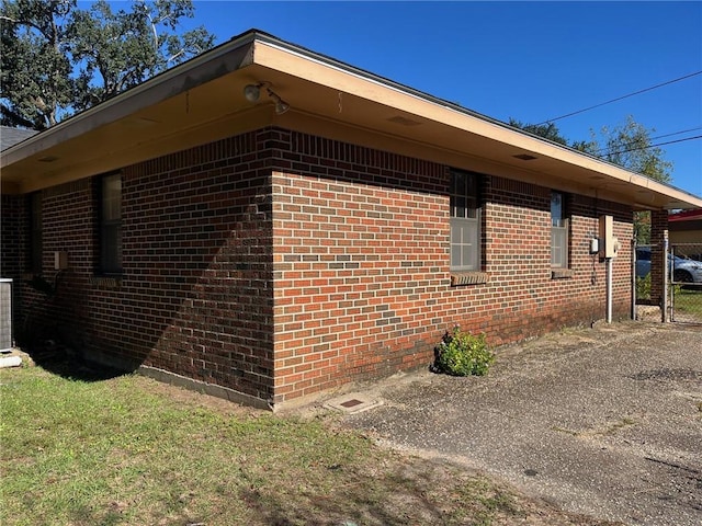 view of side of home with brick siding