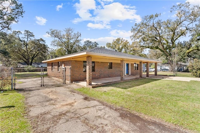 ranch-style home with brick siding, a front yard, a gate, fence, and driveway