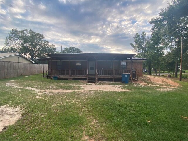 rear view of property featuring a yard