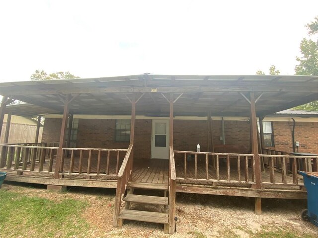 back of property featuring a wooden deck