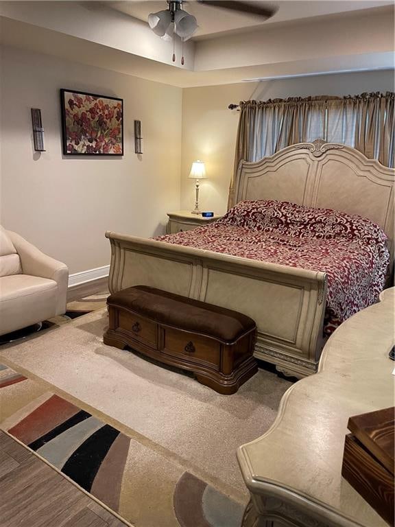 bedroom with ceiling fan and hardwood / wood-style floors