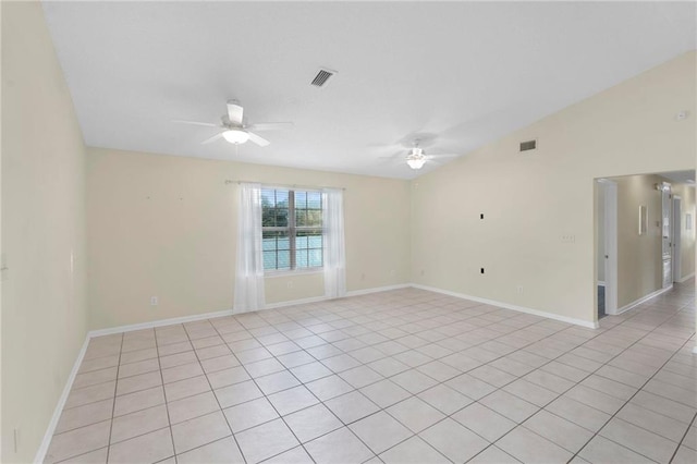 spare room featuring ceiling fan, light tile patterned flooring, and vaulted ceiling