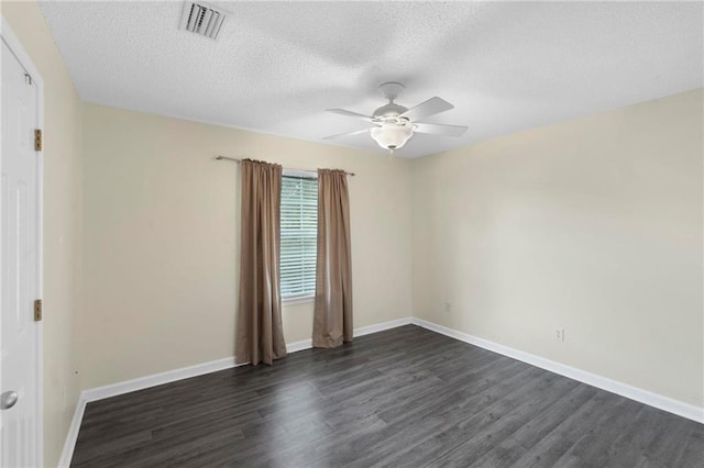 spare room featuring a textured ceiling, dark wood-type flooring, and ceiling fan