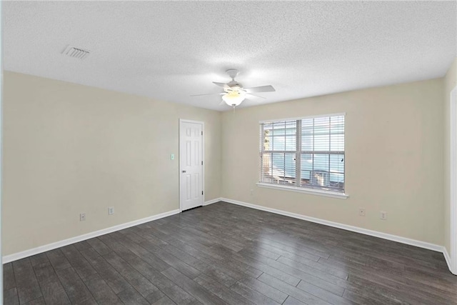 empty room featuring ceiling fan, a textured ceiling, and dark hardwood / wood-style flooring