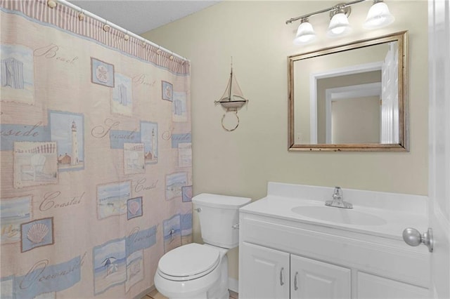 bathroom with vanity, toilet, and walk in shower