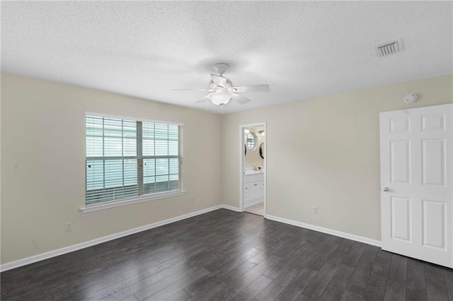 empty room featuring dark hardwood / wood-style floors, a textured ceiling, and ceiling fan