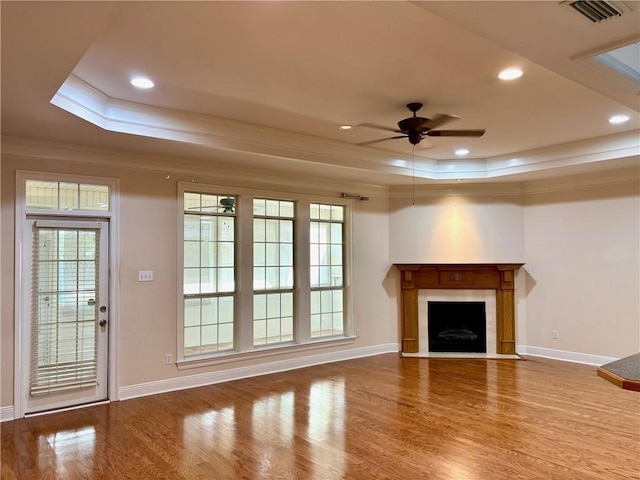 734 Natchez Trail Ct, Mobile, AL 36609 - unfurnished living room with ceiling fan, visible vents, crown molding, wood finished floors, and a tray ceiling