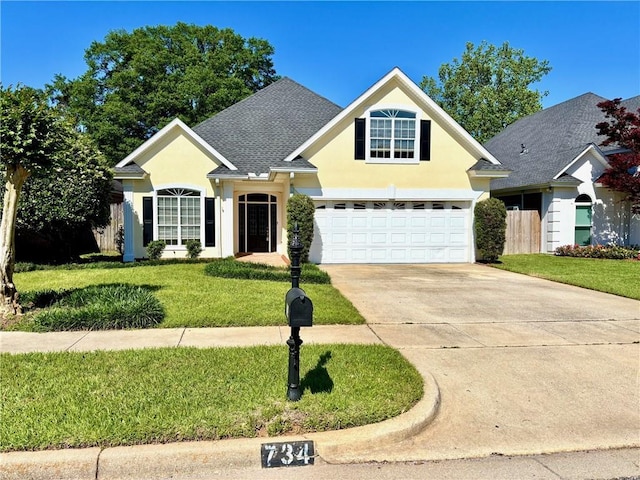 734 Natchez Trail Ct, Mobile, AL 36609 - traditional home with roof with shingles, a garage, stucco siding, a front yard, and concrete driveway