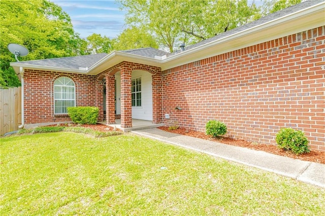 doorway to property with a yard