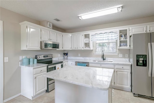 kitchen featuring white cabinets, stainless steel appliances, and sink