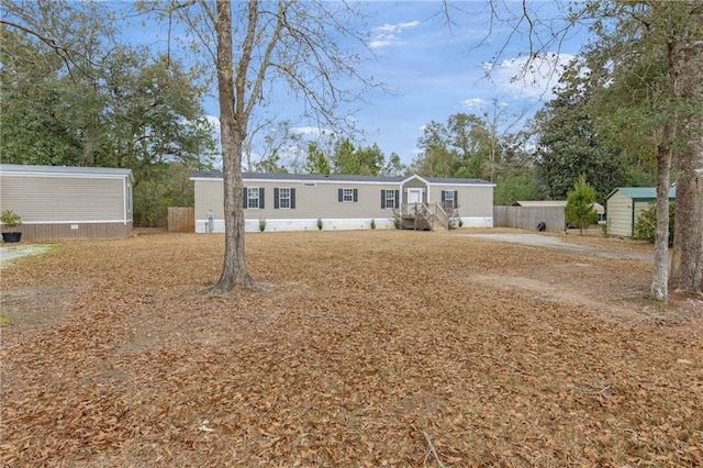 view of front facade with a storage shed