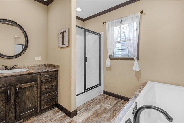 bathroom with shower with separate bathtub, wood-type flooring, crown molding, and vanity