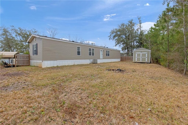 back of property with a storage unit and a lawn