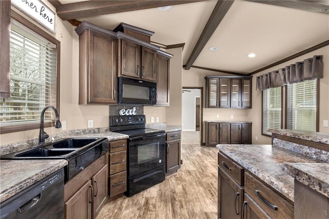 kitchen with lofted ceiling with beams, black appliances, sink, dark brown cabinetry, and light wood-type flooring