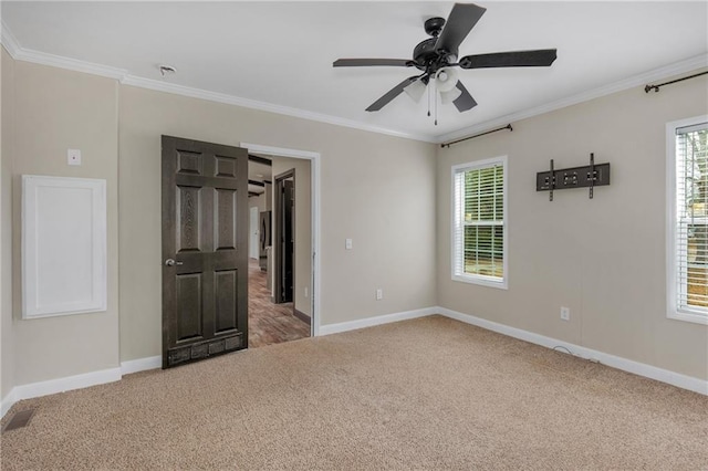 interior space featuring ornamental molding, carpet floors, and ceiling fan